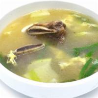 Galbi Tang / 갈비탕 · Clear broth beef rib soup with radish, scallion, and egg.
