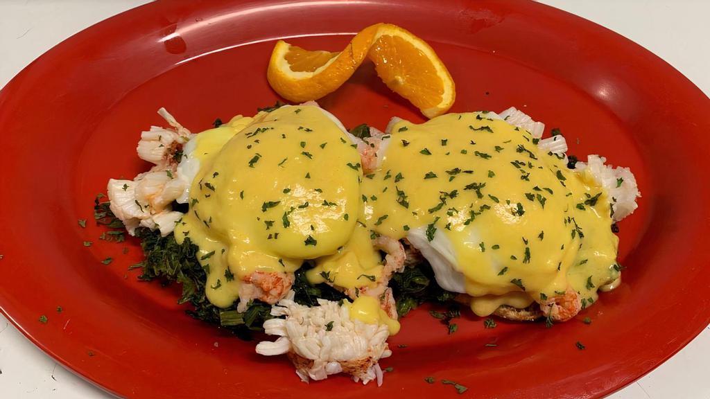 Lobster Eggs Benedict · Sauteed real lobster and spinach atop an English muffin, topped with poached eggs and hollandaise sauce. Served with your choice of one side.