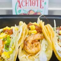 Shrimp Tacos · Blackened gulf shrimp served over corn tortilla shaved cabbage mix, chipotle sofrito, corn, ...
