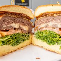 Rafa'S Stuffed Burger · Cheesy stuffed hamburger, tomato, arugula, caramelized onions, provolone cheese, and garlic ...