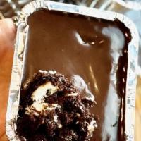 Chococo Tin Cake · Chocolate-coconut cake topped with gourmet Brigadeiro chocolate, served chill in a tin. Serv...