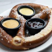 Oven Baked Soft Pretzel · One freshly baked jumbo pretzel, buttered and salted. Served with a Jalapeño Jam, Sweet Must...