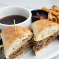 French Dip Sandwich · Slow roasted, thinly sliced beef tip topped with melted provolone cheese piled high on a Par...