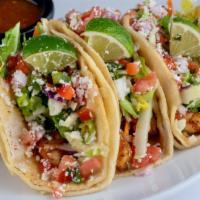 Baja Fish Tacos - Shrimp · Double stacked warm corn tortillas spread with chipotle aioli and layered with seasoned shri...