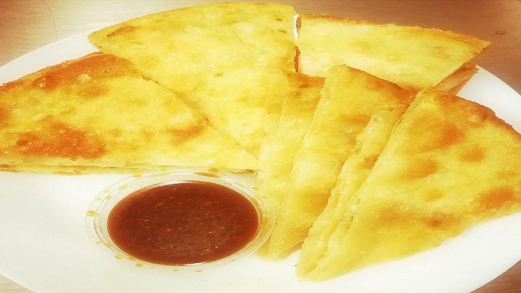 Scallion Pancake(8) · 8pcs.Unleavened bread with flecks of scallion served with ginger sauce.