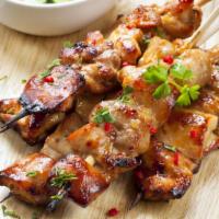 Chicken Satay  · Inviting, grilled marinated chicken skewered on three bamboo sticks. Served with a side of p...
