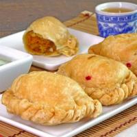 Vegetable Curry Puff · Fried dough filled with delicious yellow curry, chopped potatoes and onions. Served with ref...