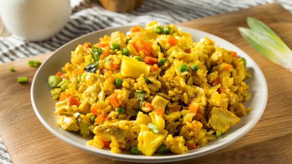 Pineapple Fried Rice Dinner · Mouth watering fried rice with your choice of meat, juicy pineapples, cashew nuts, green onions and white onions, peas, carrots, and egg.