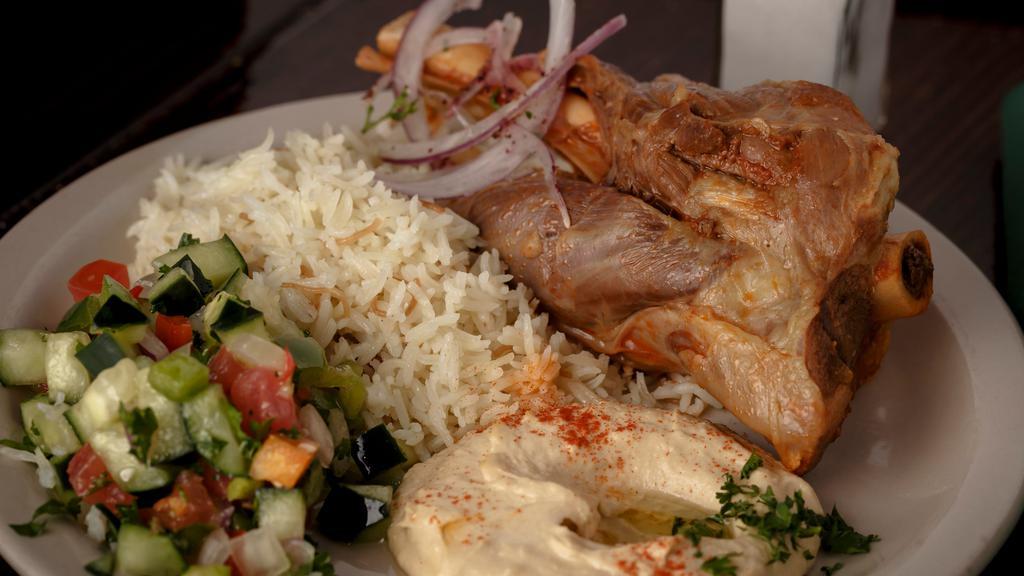 Lamb Shank · Customer favorite. Hearty portions arrive on the bone.
Served on a bed of Middle-Eastern rice, hummus, Jerusalem salad and pita bread.