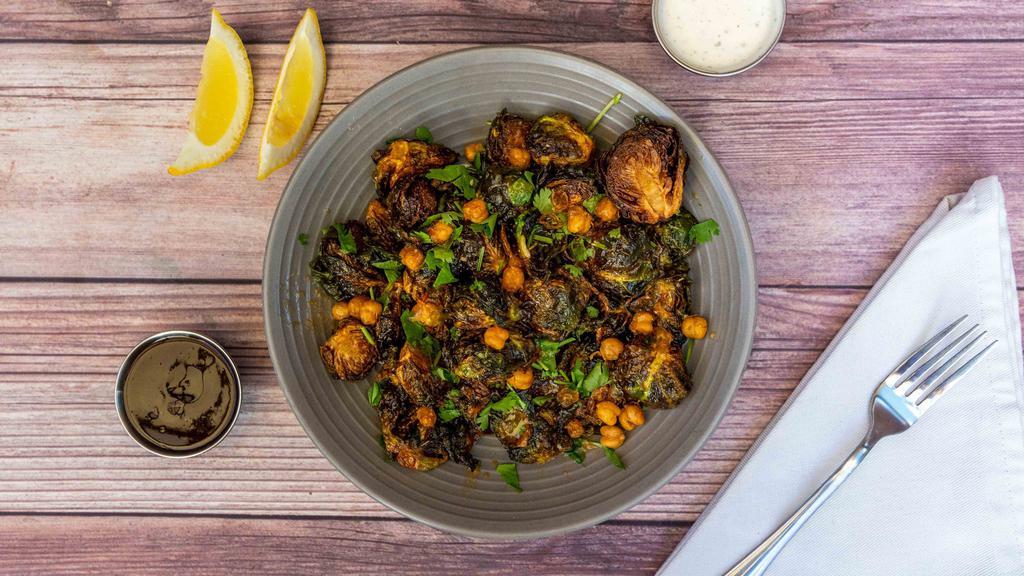 Crispy Brussels Sprouts · Chile fish sauce, roasted chickpeas and cilantro.