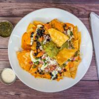 Bayside Nachos · Crispy tortilla chips topped with queso, pico de gallo, black beans, cotija cheese, salsa ve...