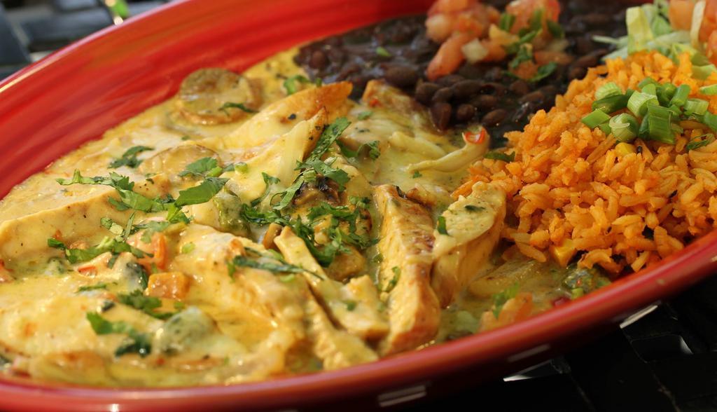 Pollo Poblano · Sliced grilled chicken breast sautéed with mushrooms, poblano peppers, onions, pico de gallo, sautéed with our signature chipotle cream sauce. Served with black beans, rice, and tortillas.