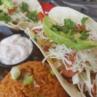 Fish Tacos Del Rio · Grilled tilapia, sautéed red and green peppers, shredded cabbage, pico de gallo, monterey ja...