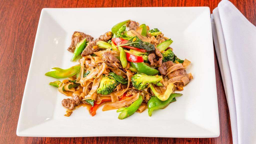 Pad Kee Mow (Drunken Noodles) · Flat noodles with basil, eggs, Chinese broccoli, broccoli, mushroom, bell peppers and bok choy.
