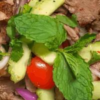 Beef Salad · Grilled sliced New York Steak, Cucumber, Tomato, Cilantro and Onions in spicy lime juice on ...