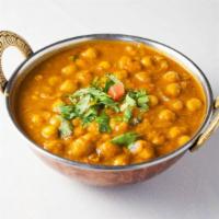 Chana Saag · Garbanzo beans cooked with pureed spinach with ginger, garlic and spices.