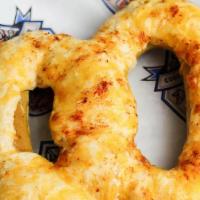 Crab Pretzel · Jumbo pretzel topped with crab dip and Cheddar cheese.