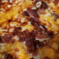 Loaded Fries · Fries layered with cheddar & mozzarella with bacon and baked in the oven to golden perfection.