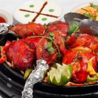 Tandoori Chicken · Chicken with bone, marinated in yogurt, ginger, garlic and freshly ground spices, skewered a...