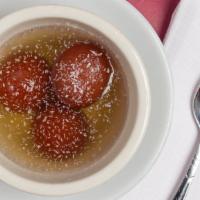 Gulab Jamun · Reduced milk balls served in flavored sugar syrup qith a touch of cardamom.