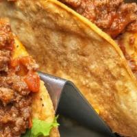 Crunchy Ground Beef Taco · House-made crunchy taco shells, lettuce, tomato, onion, cheddar & sour cream