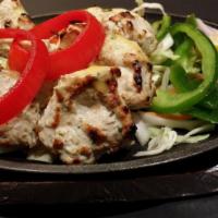 Chicken Malai Kabab  · Delicately flavored bite-sized chicken pieces marinated in ginger, garlic, cheese & yogurt.