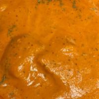 Chicken Tikka Masala  · Tandoori cooked chicken cubes simmered in creamy tomato sauce, accented with dry fenugreek