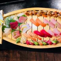 Sushi & Sashimi Love Boat · Raw and spicy. Ten pieces sushi, eighteen pieces sashimi, American Dream roll, and ocean.

C...