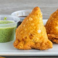 Vegetable Samosa · Spiced vegetable turnover filled with potatoes peas and herbs, then fried.