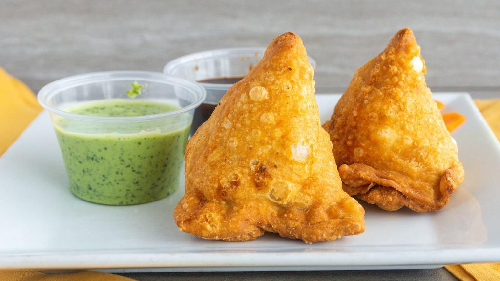 Vegetable Samosa · Spiced vegetable turnover filled with potatoes peas and herbs, then fried.