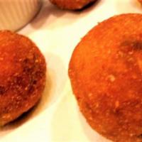 Arancini · Risotto-style filled with bolognese meat, peas and fresh mozzarella, served with a side of t...