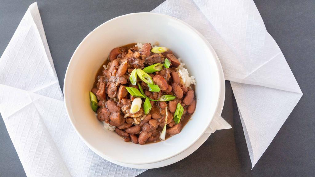 Red Beans & Rice · Slow cooked red beans, smoked sausage, smoked turkey, onions, garlic, green peppers, garlic, celery, with creole seasoning.