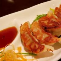 Dumplings · Veggie or pork and chicken served with tangy soy dipping sauce.