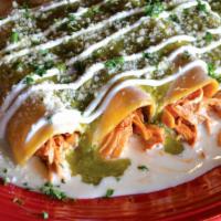 Enchiladas Suizas · Four corn tortillas, filled with chicken and topped with cheese sauce, green tomatillo sauce...