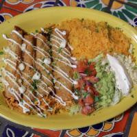 Flautas · Four rolled, fried corn tortillas, two filled with beef tips and two with chicken, served wi...
