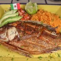 Mojarra Frita · Whole tilapia fish seasoned and fried. Served with rice, pico de gallo salad, sliced avocado...