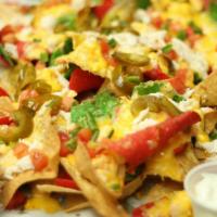 Tower Nachos · Tortilla chips topped with tomatoes, jalapeños, scallions, and a blend of cheeses.