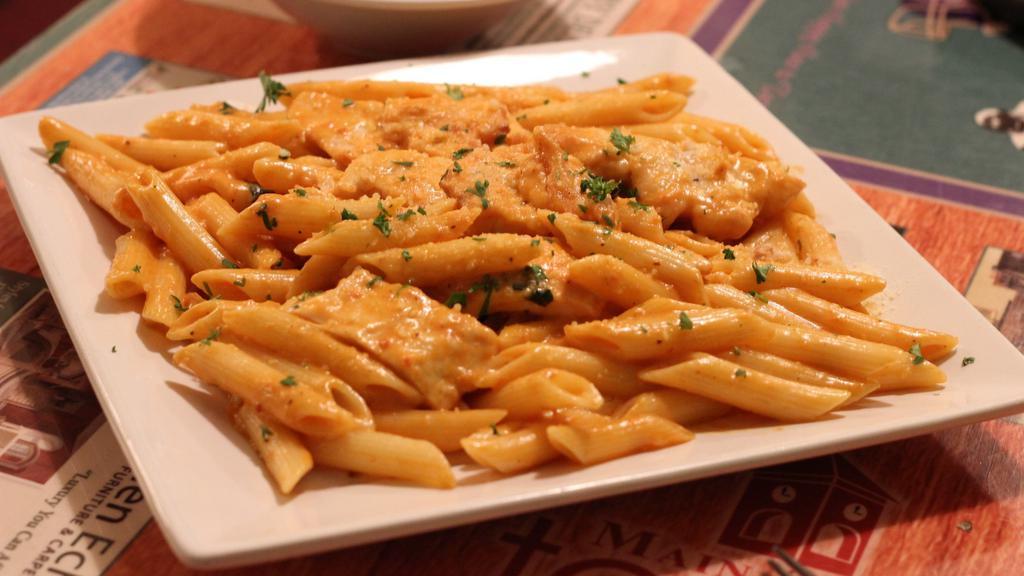 Penne Vodka · Bacon sauteed and splashed with vodka, simmered in a pink sauce with a touch of parmesan cheese, tossed in penne pasta.