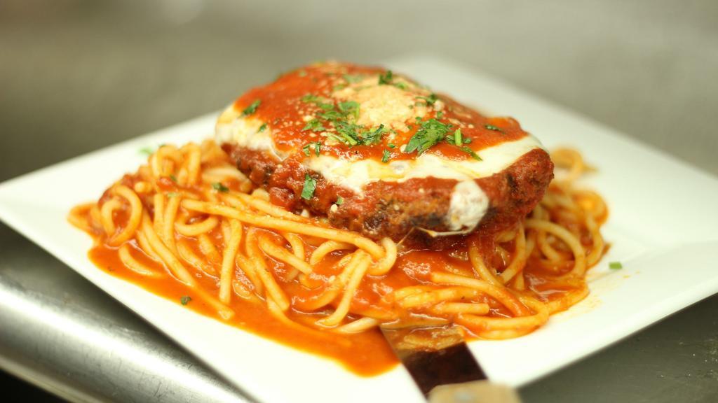 Chicken Parmesan · Breaded chicken breast baked with tomato sauce, topped with fresh mozzarella. Served over spaghetti.
