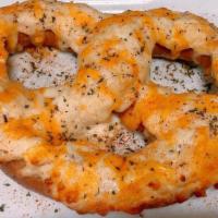 Crab Pretzel · A large soft pretzel baked with crab dip and melted shredded cheese, topped with old bay