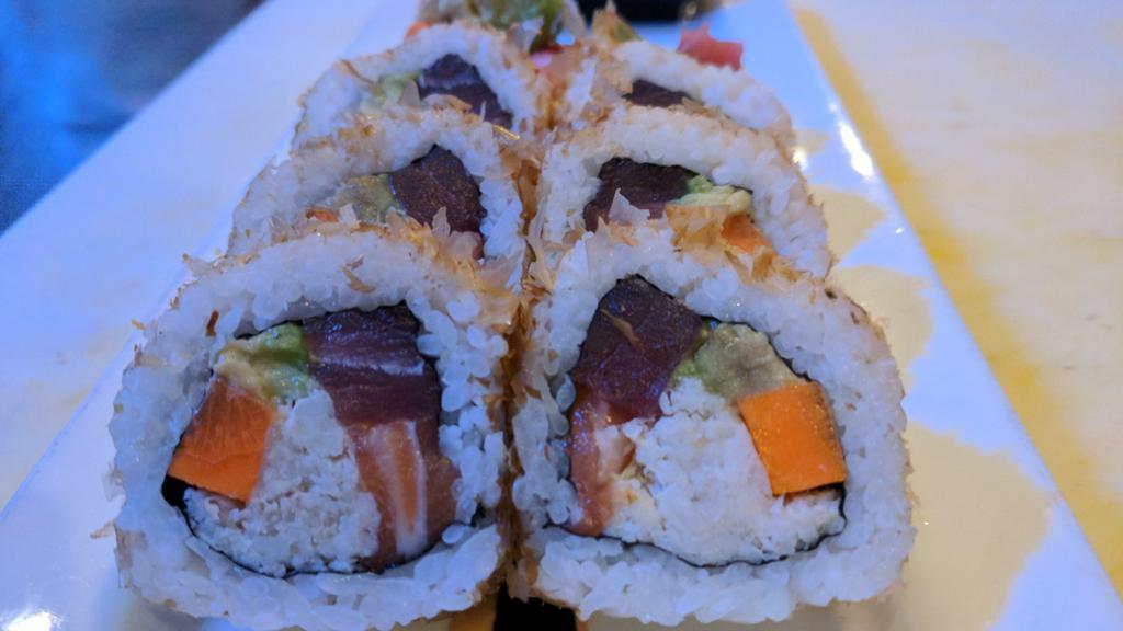 The Robo Roll · Inside out roll (sushi rice on the outside). Salmon, yellowfin ahi tuna, crab, avocado, carrot, and spicy mayo with dried bonito flakes dusted on the outside.