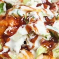 Texas Buffalo Chicken Bowl · Buffalo chicken on a bed of rice or lettuce with tomatoes, onions, and blue cheese with a dr...