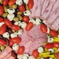 Antipasto Italiano Salad · Our garden salad topped with Genoa salami, capicola and peppered ham, provolone, pepperoncin...