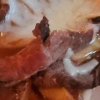 Not Your Routine Poutine · Thinly sliced carne asada on top of our hand cut fries covered in gravy and topped with mozz...