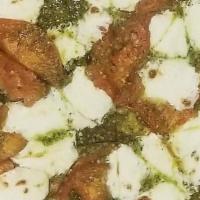 Pesto · Classic dough, fresh basil pesto, mozzarella, roasted tomato slices