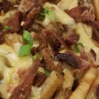 Loaded Fries · Our famous hand cut fries, topped with our house made queso, bacon and green onions.