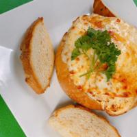 Crab Dip  · Served in a bread boule stuffed with creamy crab dip and provolone cheese.