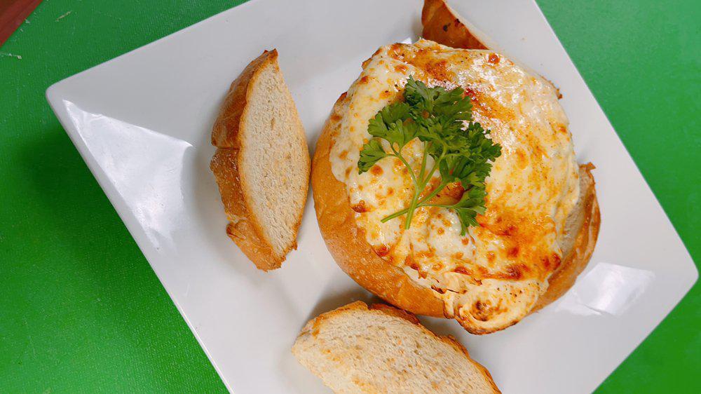 Crab Dip  · Served in a bread boule stuffed with creamy crab dip and provolone cheese.