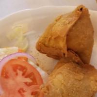 Vegetable Samosa · Deep fried turnover stuffed with potatoes and green peas ( 2 Pieces)