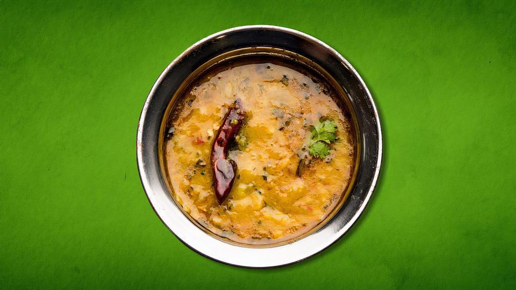 Divine Daal Yellow(Vegan) · Yellow lentils cooked to perfection in a traditional Indian wok with a rare herbs and spices garnished with tarka cilantro.